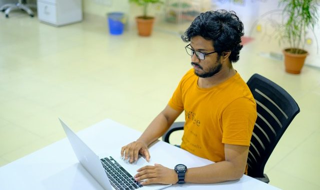 Agile Scrum software developer looking at computer screen